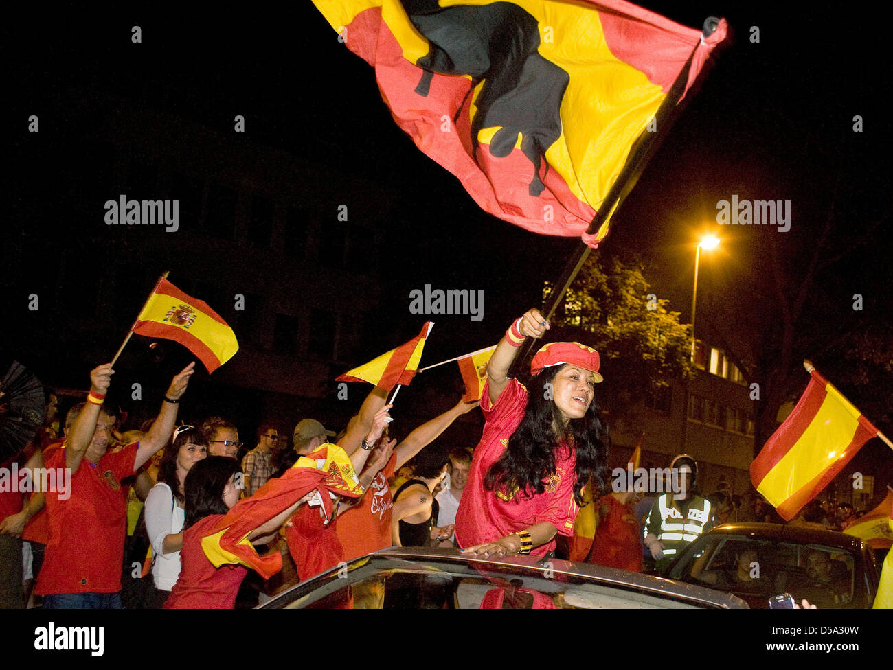 With flags, Spanish fans celebrate the victory of their team of the final match Spain vs. the Netherlands of the 19th FIFA World Cup 2010 on the streets of Hannover, Germany, 11 July 2010. Spain won against the Netherlands 1-0 and has is World Cup- holder for the first time ever. Photo: Michael Löwa Stock Photo