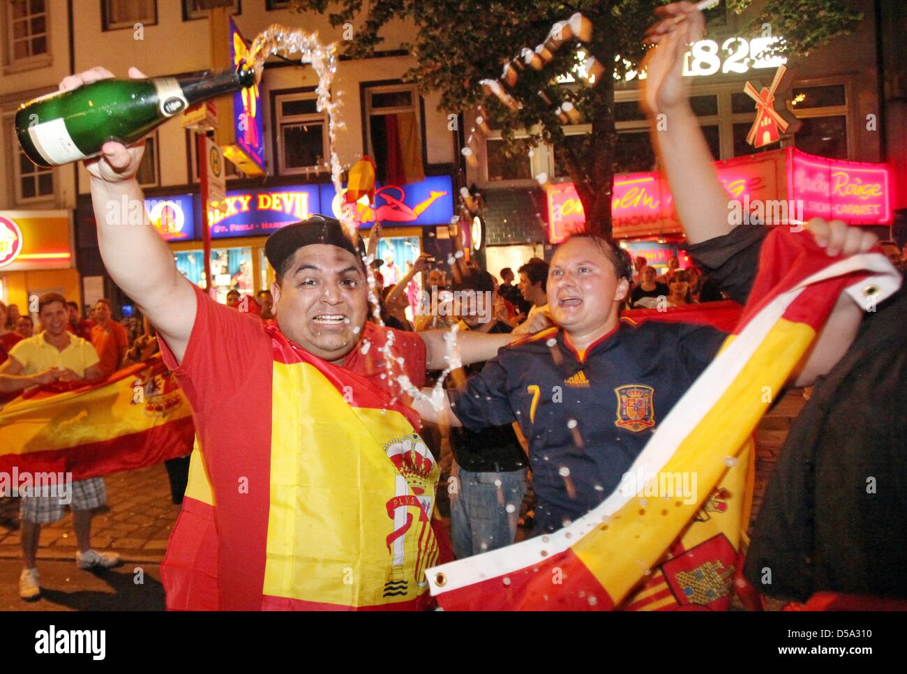 Spanish soccer fans celebrate the victory of their team on the Reeperbahn in Hamburg, Germany, 11 July 2010. Spain won the final match of the FIFA World Cup 2010 in South Africa against the Netherlands with the score 1-0. Photo: Bodo Marks Stock Photo