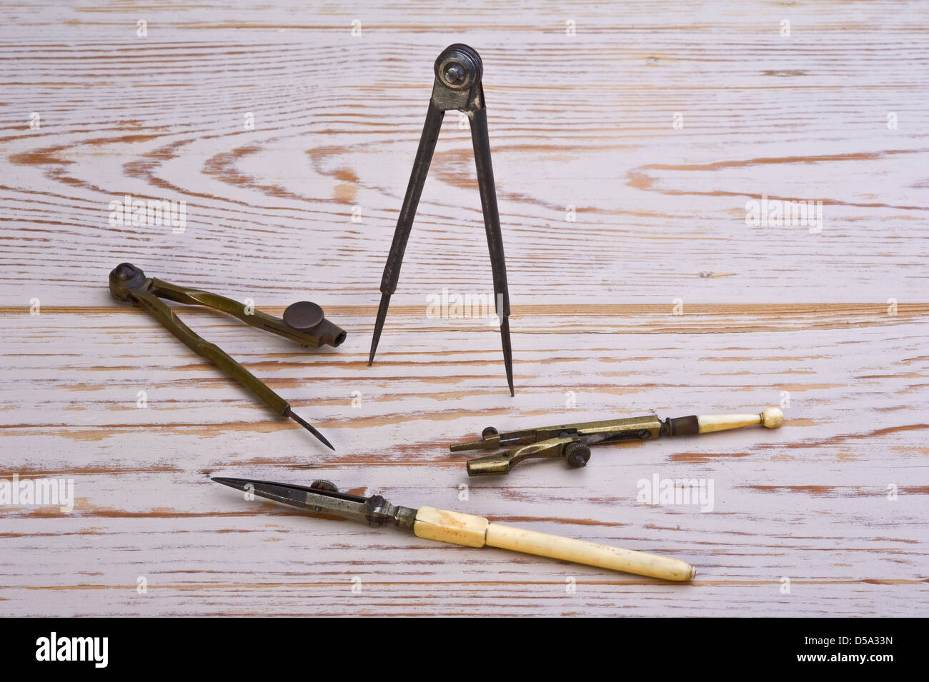Antique technical drawing instruments, on an old distressed table. Stock Photo