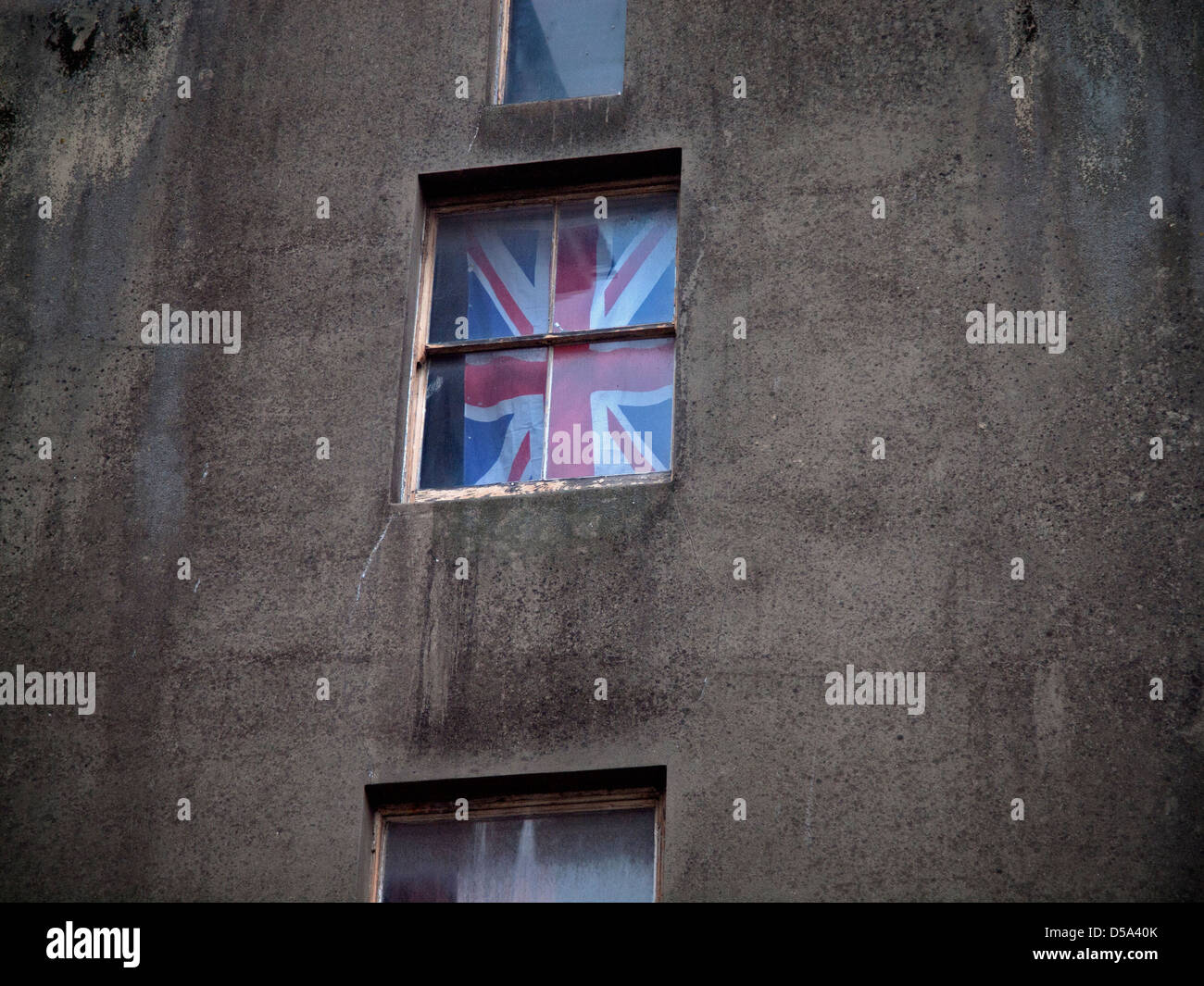 A flag flies in the window of a run-down building in Brighton Stock ...