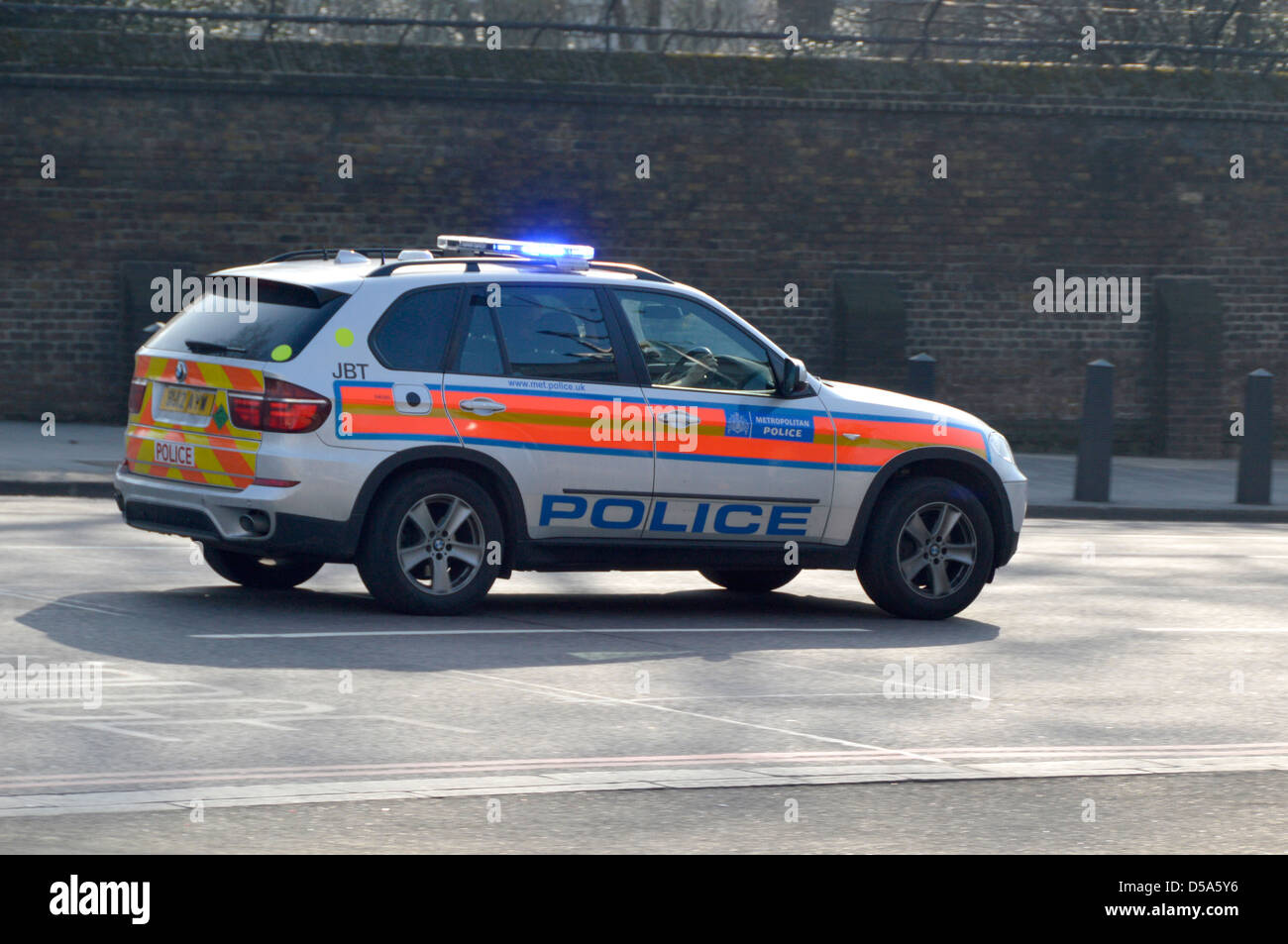 Metropolitan Police car at speed with emergency blue lights Stock Photo