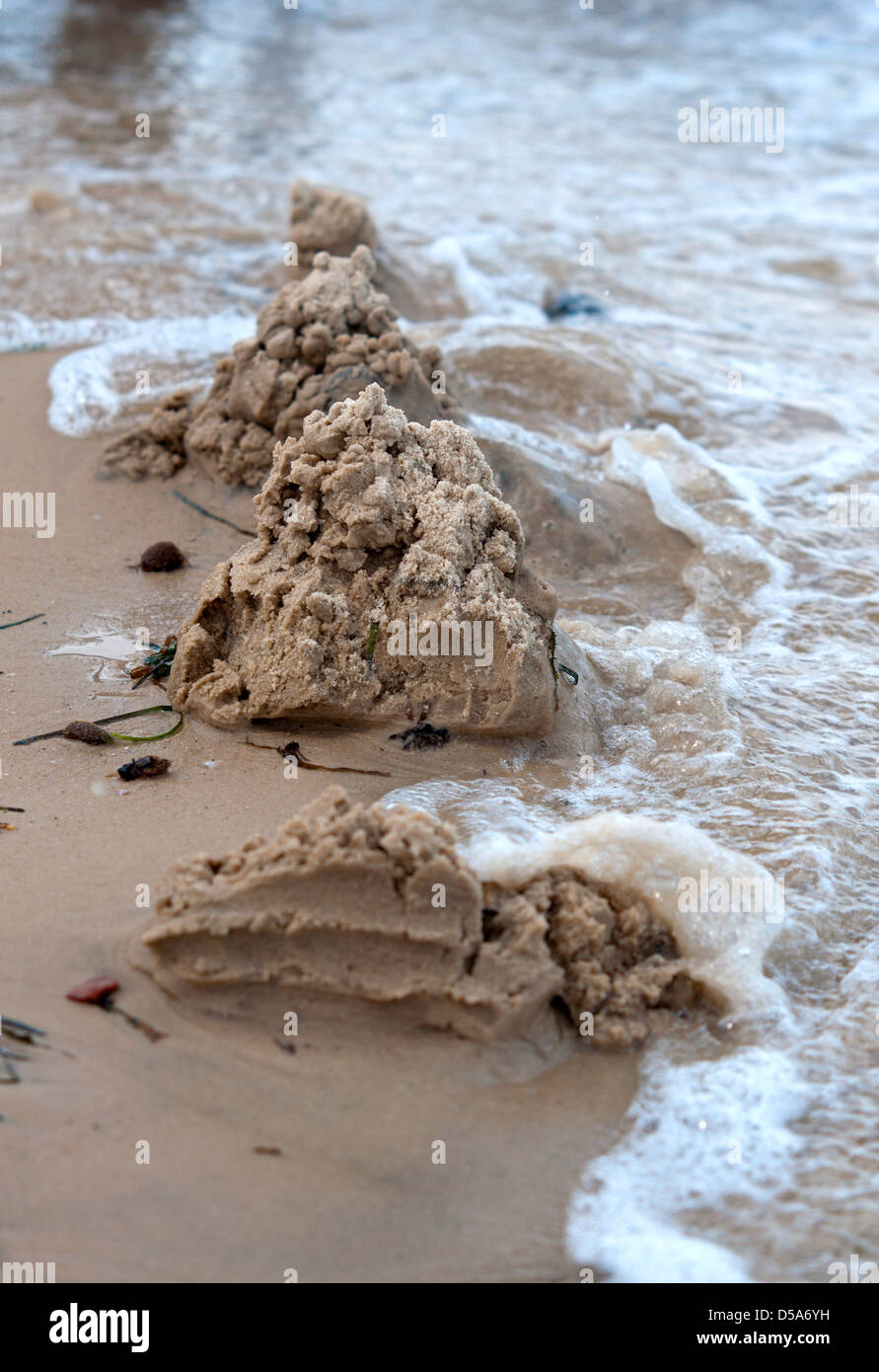 Sand castle destroyed by water wave Stock Photo Alamy
