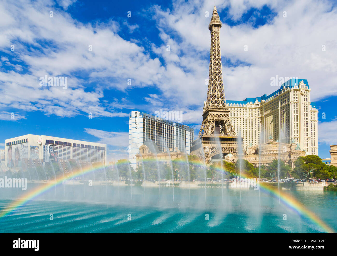 Water fountains and rainbow outside the Bellagio hotel with Paris hotel behind, The Strip, Las Vegas Boulevard South, Las Vegas Stock Photo