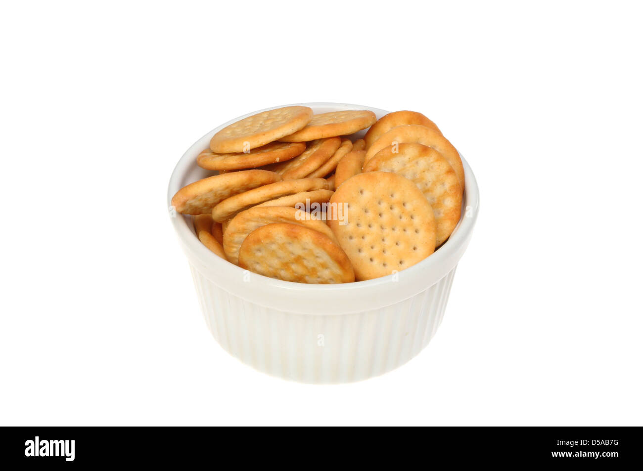 Mini savory cheese biscuits in a ramekin isolated against white Stock Photo