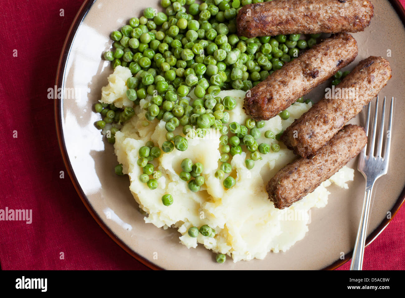 Veggie sausages with mashed potatoes and green peas Stock Photo