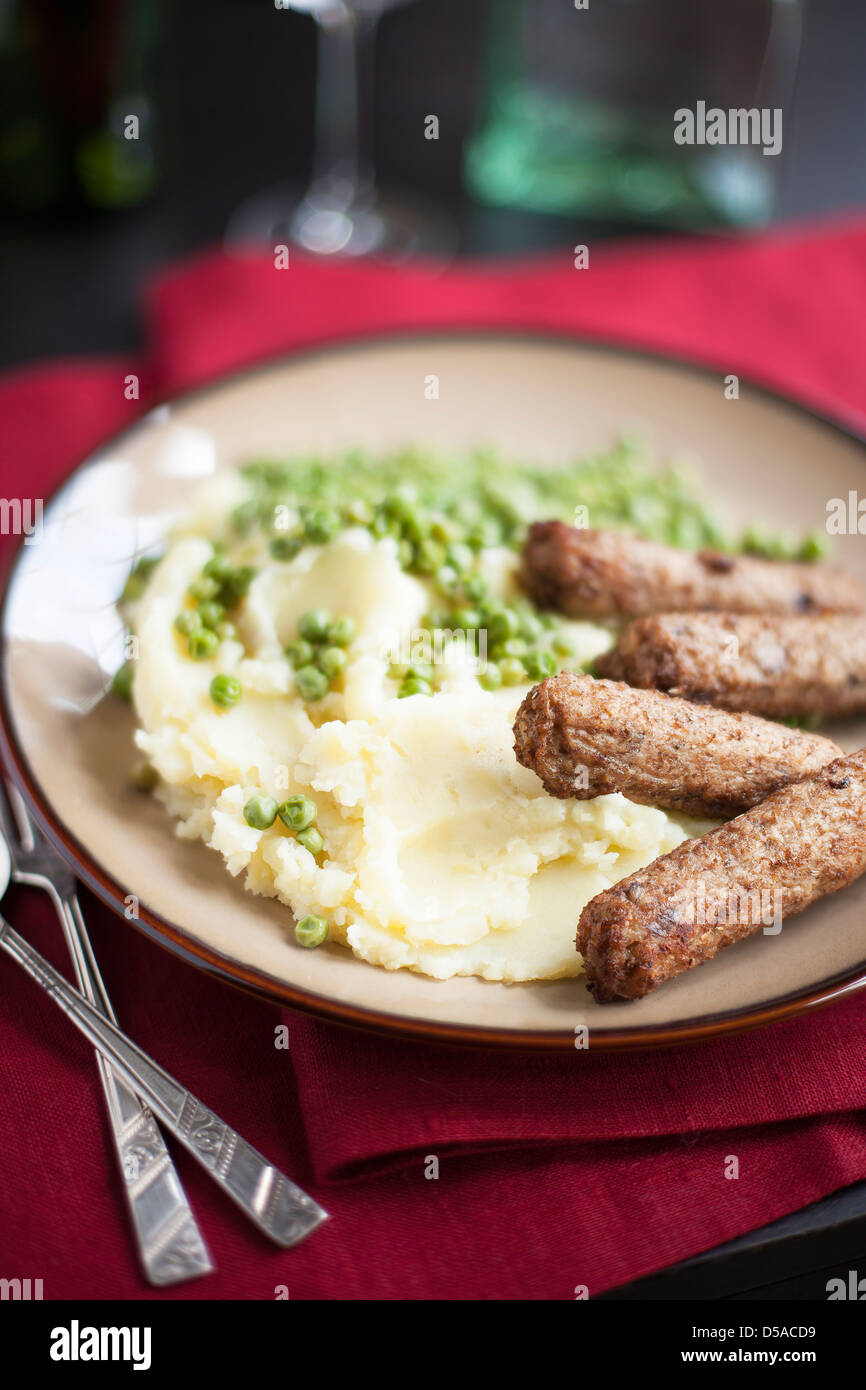 Veggie sausages with mashed potatoes and green peas Stock Photo