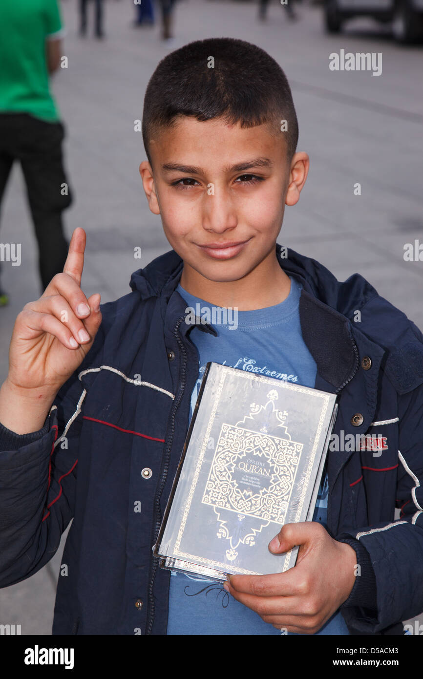 Berlin, Germany, boy Karim, 10 years old shows, with a wagging finger the Koran Stock Photo