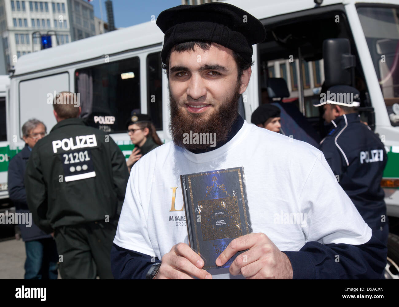 Berlin, Germany, shows man the Koran, in the background, police Stock Photo