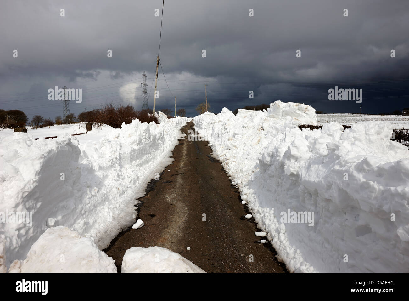 country lane with heavy drifts of snow county antrim northern ireland uk Stock Photo