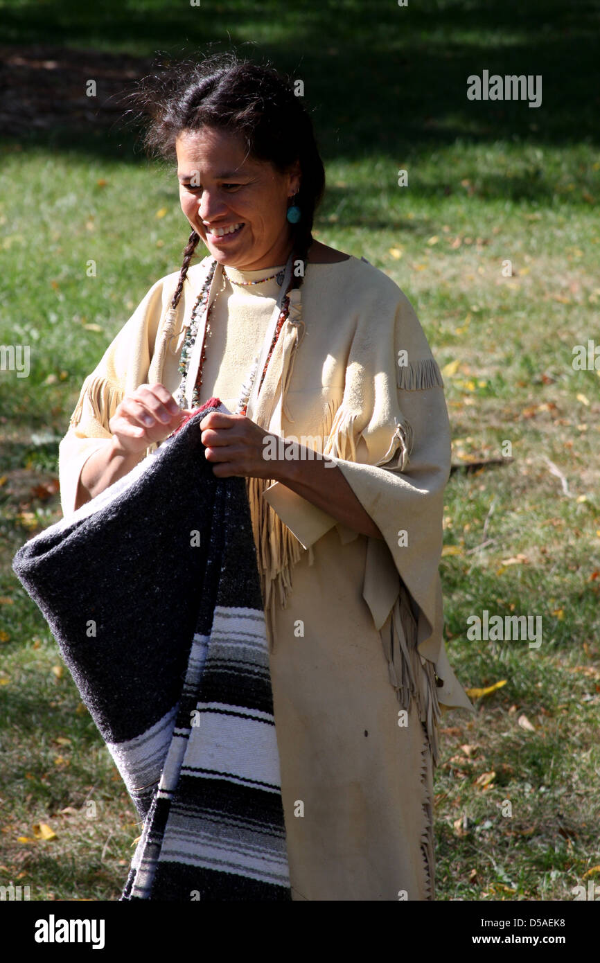 A Native American Indian woman folding a blanket Stock Photo Alamy
