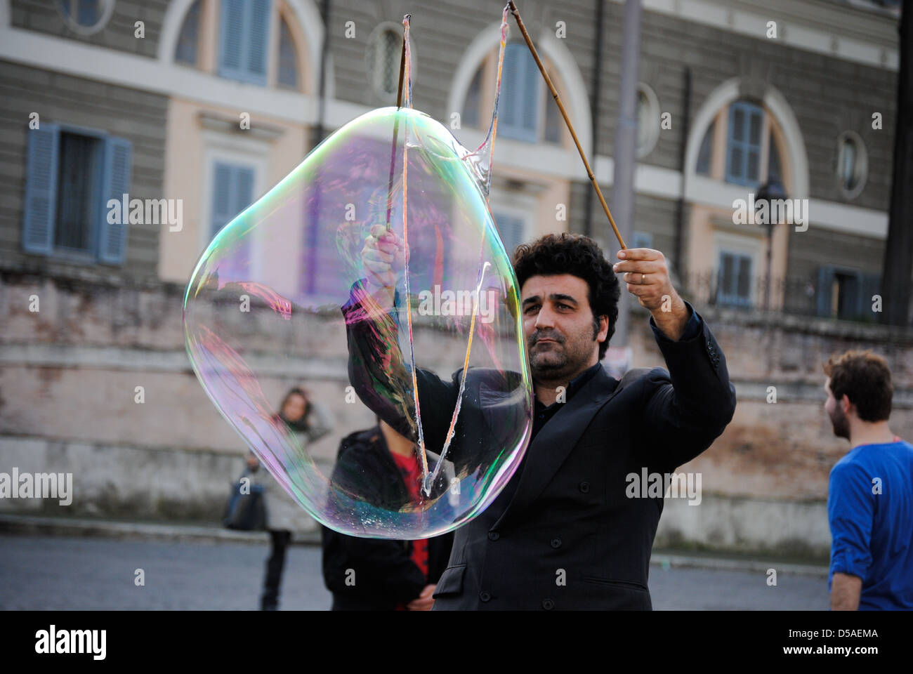 A man making huge soap bubbles in Piazza del Popolo, Rome, Italy Stock ...