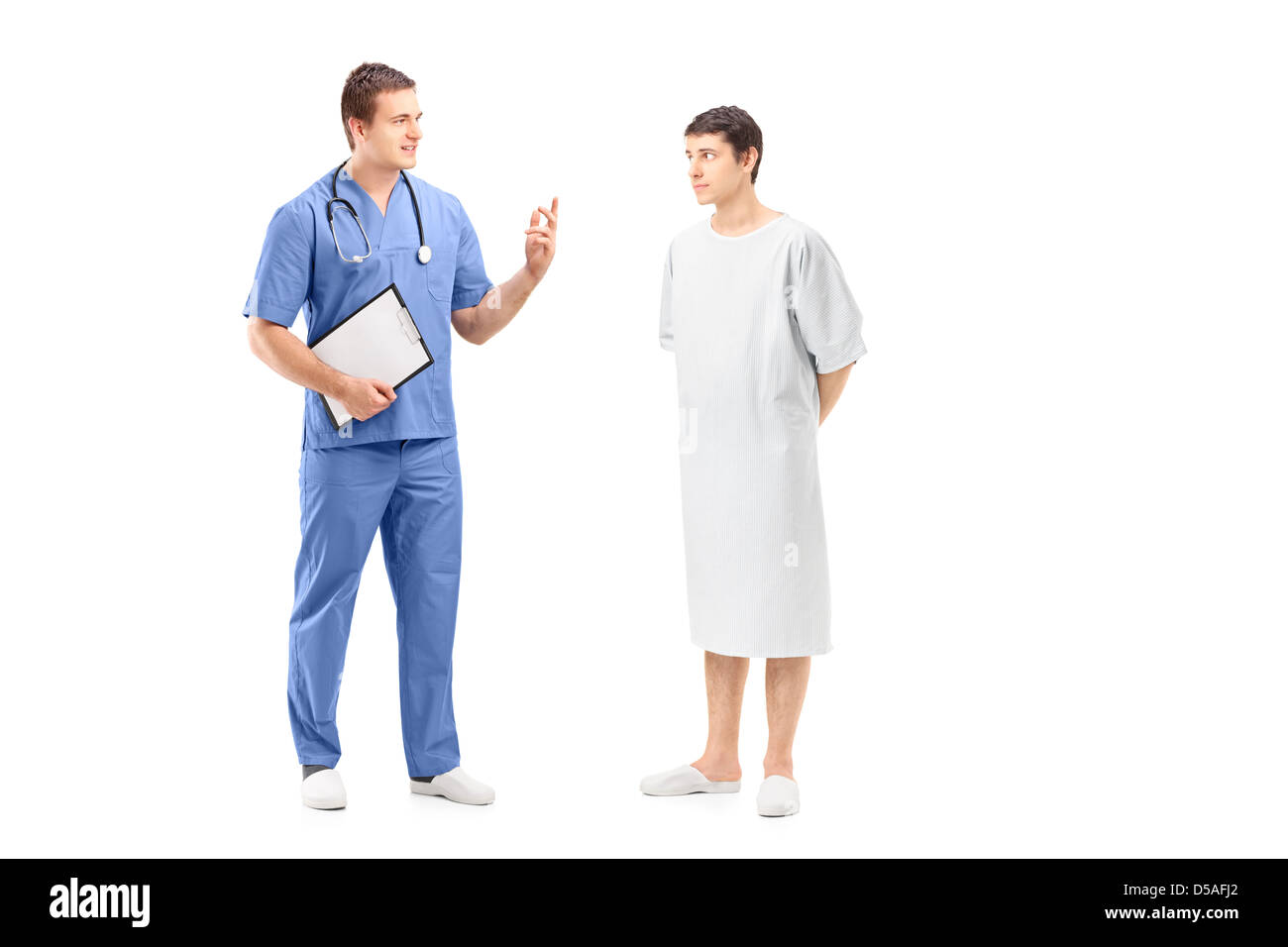 Full length portrait of a male patient in a hospital gown and medical practitioner during a discussion isolated on white Stock Photo