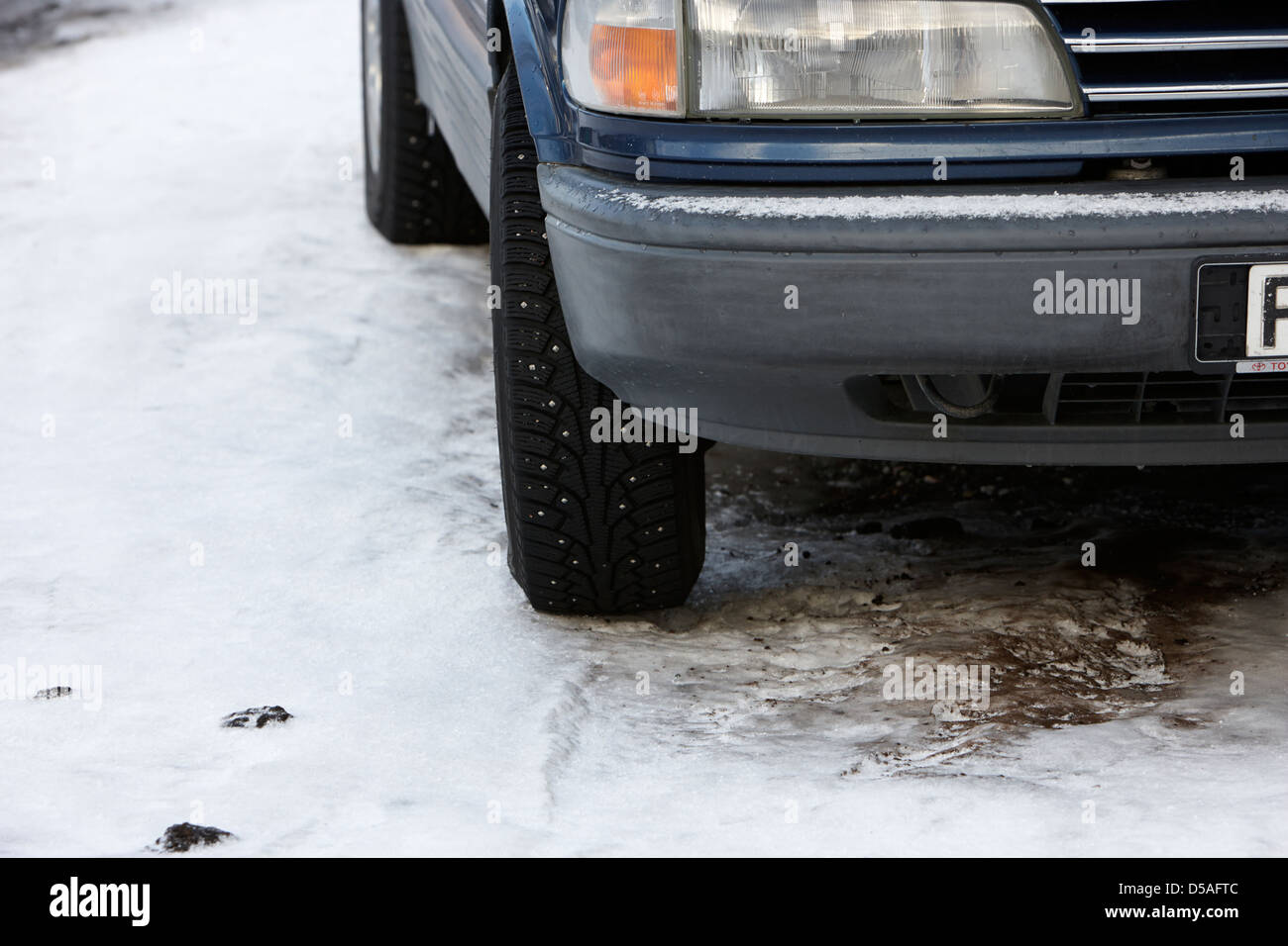 car with studded winter tyres parked on ice in kirkenes finnmark norway europe Stock Photo