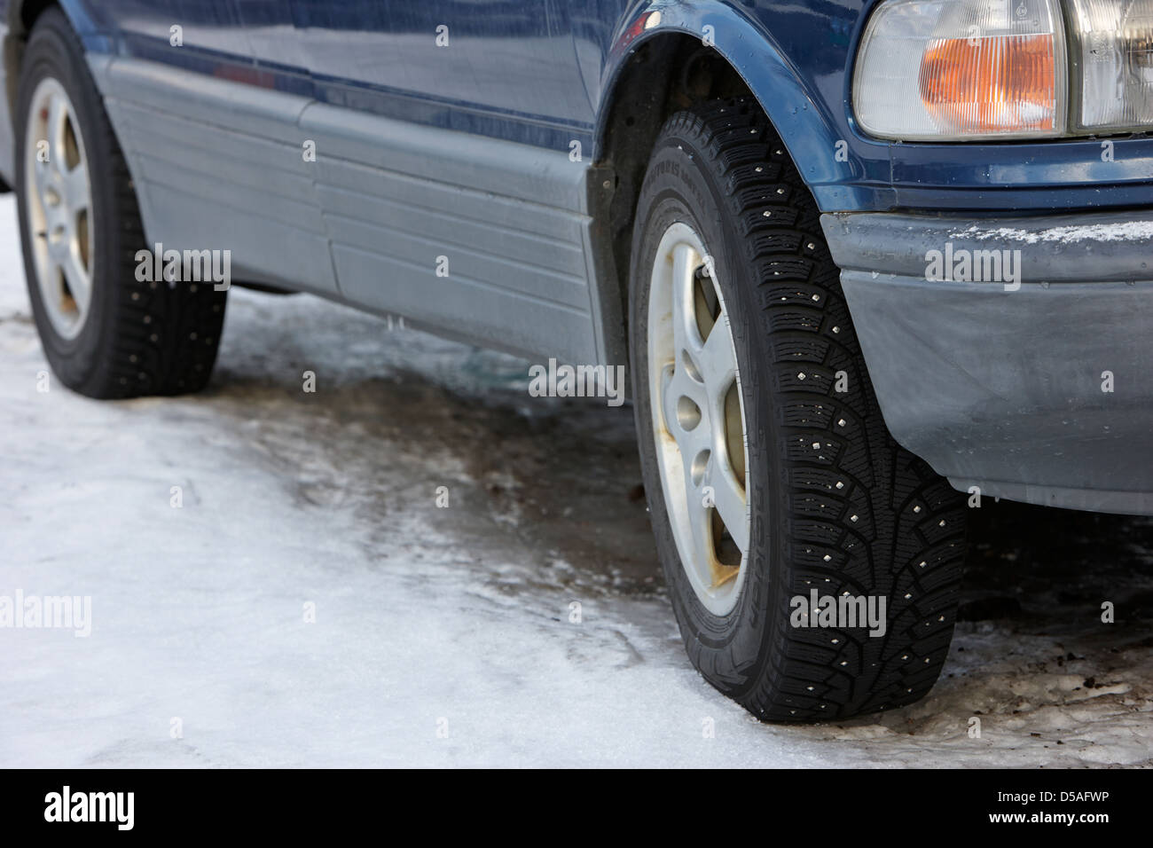 car with studded winter tyres parked on ice in kirkenes finnmark norway europe Stock Photo