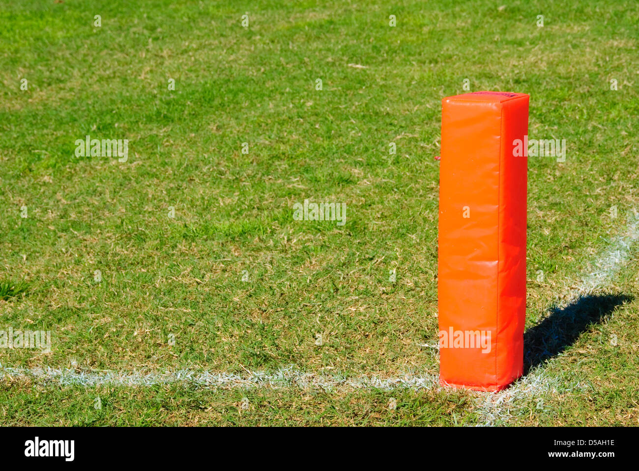 Orange Pylon on a football field. Stock Photo