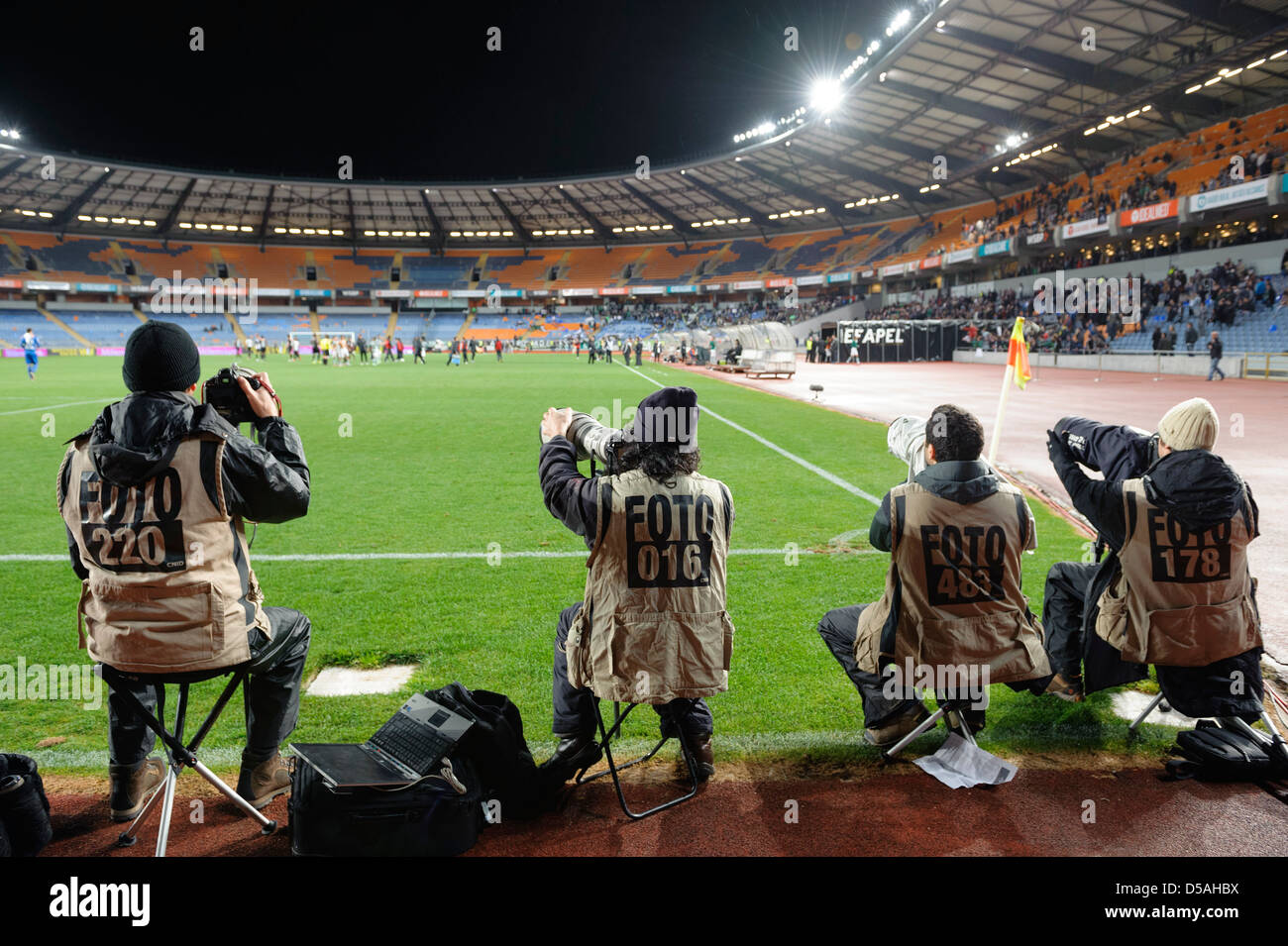 Professional photojournalists taking photos at sporting event Stock Photo