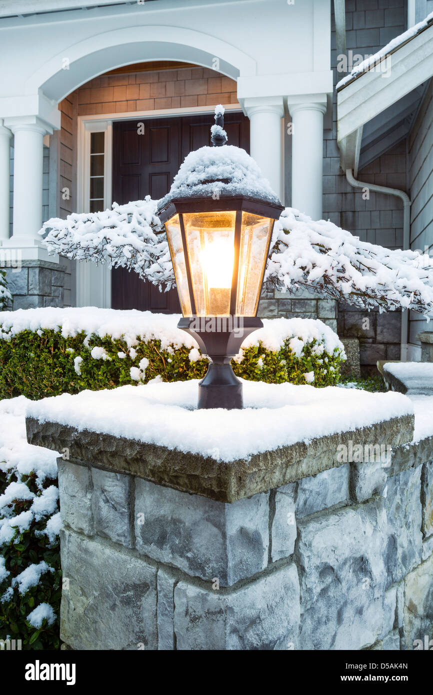 Vertical photo of lamp post, with snow on top, in front of suburban home  Stock Photo - Alamy