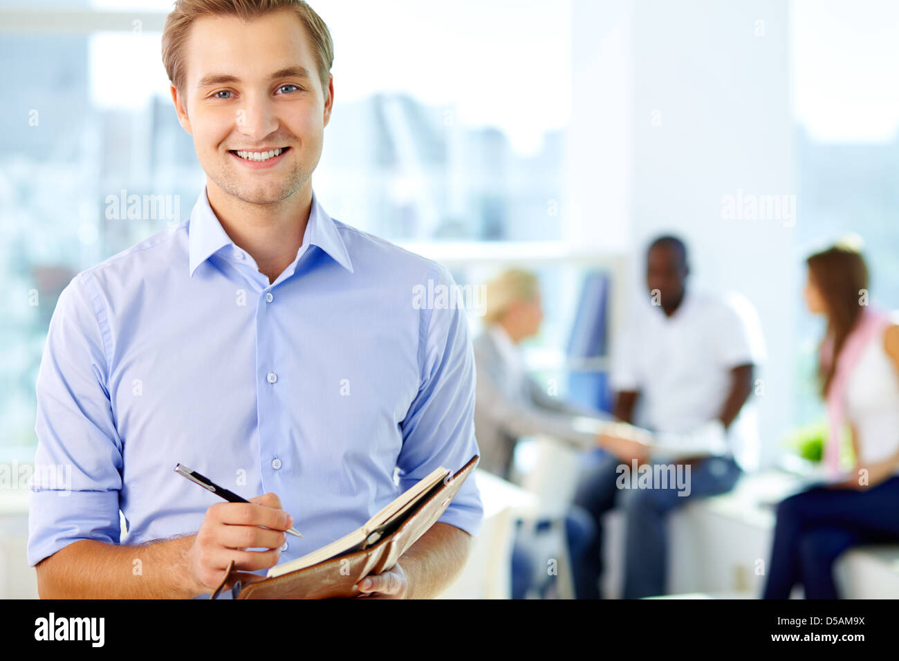 Portrait of a business guy writing in his organizer Stock Photo Alamy