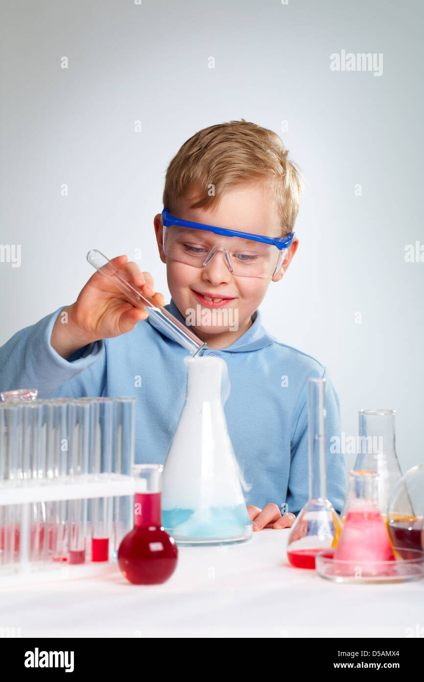 Vertical shot of an enthusiastic school guy being happy about successful experiment Stock Photo