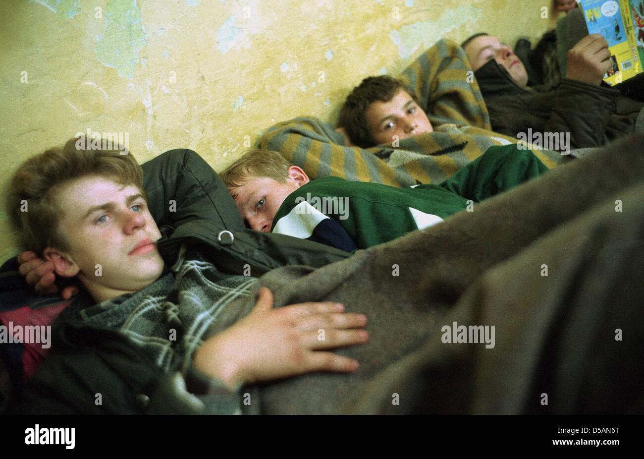 Exhausted Bosniak refugees lying on the floor in a basement, Travnik, Bosnia and Herzegovina Stock Photo