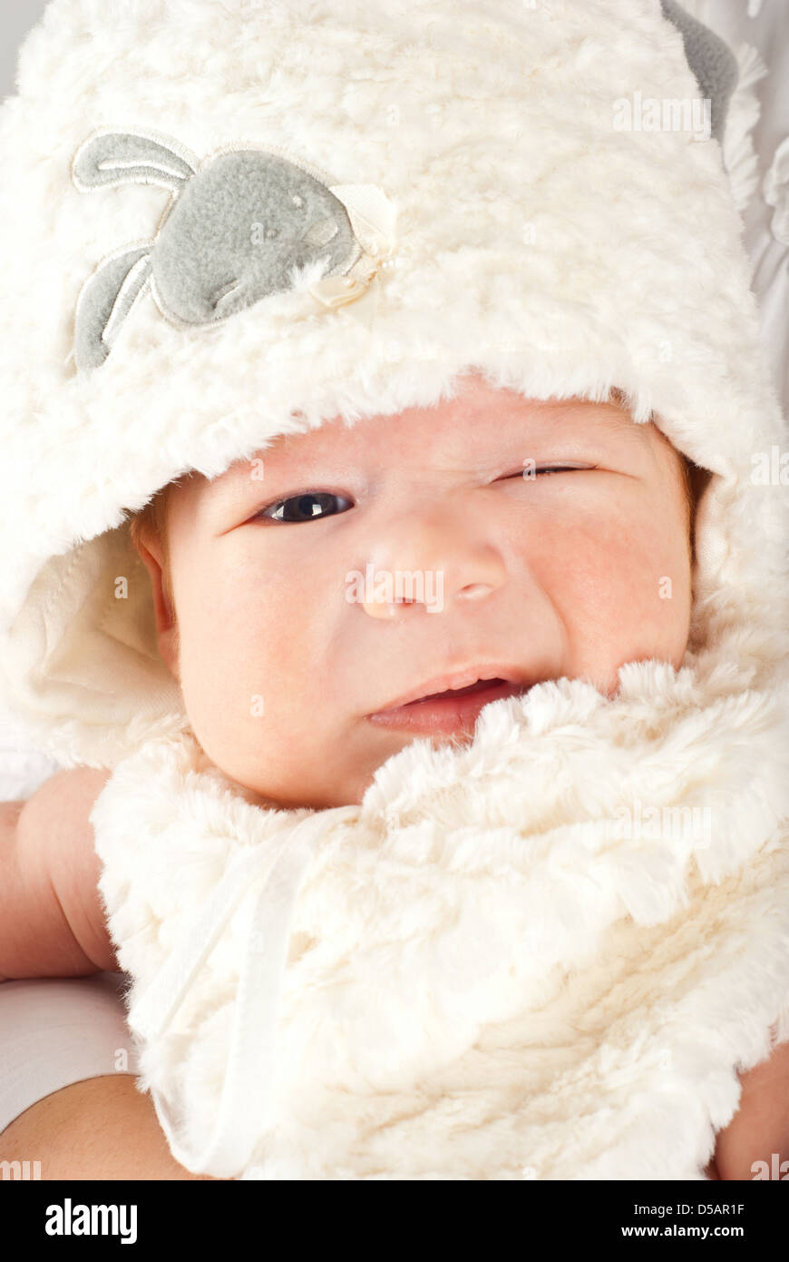 Wink Easter newborn baby boy with fur bunny cap Stock Photo