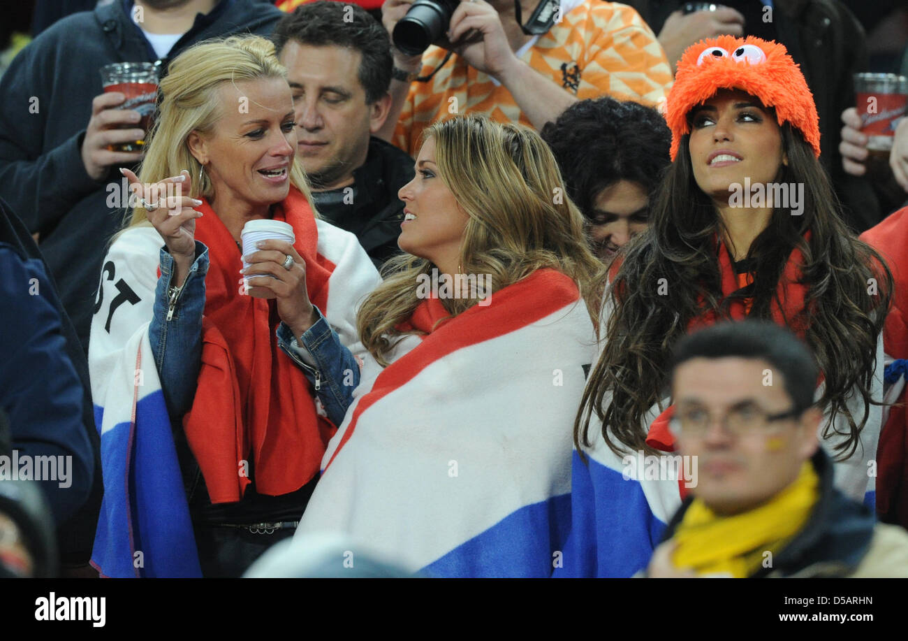 Yolanthe Cabau van Kasbergen (R), girlfriend of Dutch player Wesley Sneijder, Charlotte Zenden (C), girlfriend of Dutch player John Heitinga, and the partner of Sander Boschker on the stand during the 2010 FIFA World Cup final match between the Netherlands and Spain at Soccer City Stadium in Johannesburg, South Africa 11 July 2010. Photo: Marcus Brandt Stock Photo