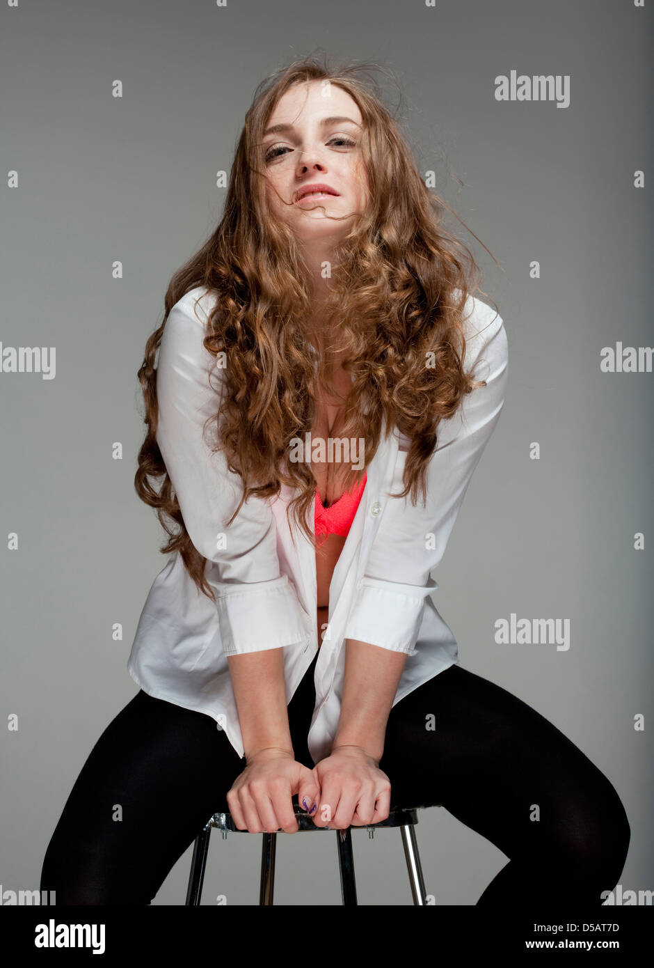 portrait of a young beautiful woman with brown hair - isolated on gray ...