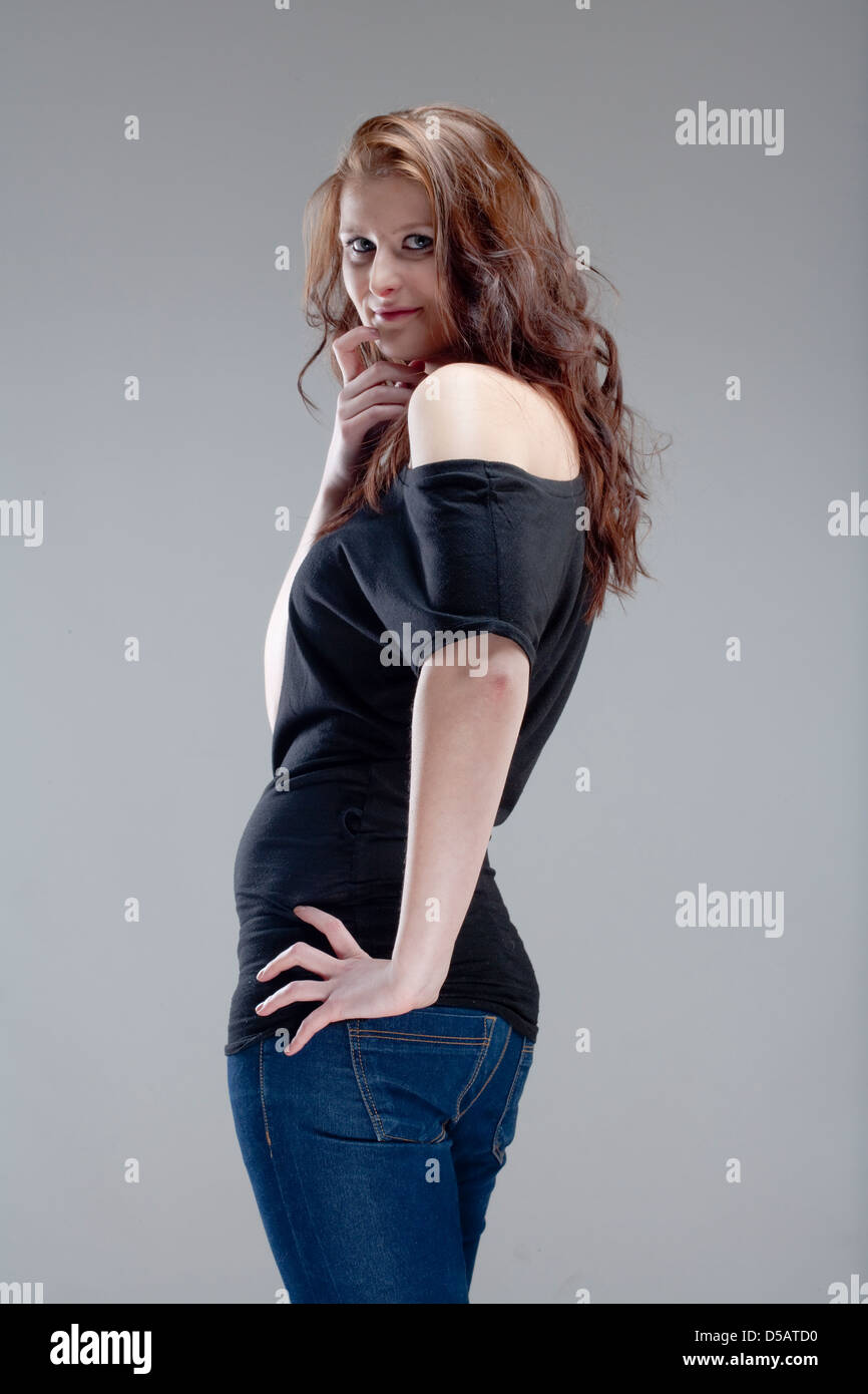 portrait of a young beautiful woman with brown hair - isolated on gray ...