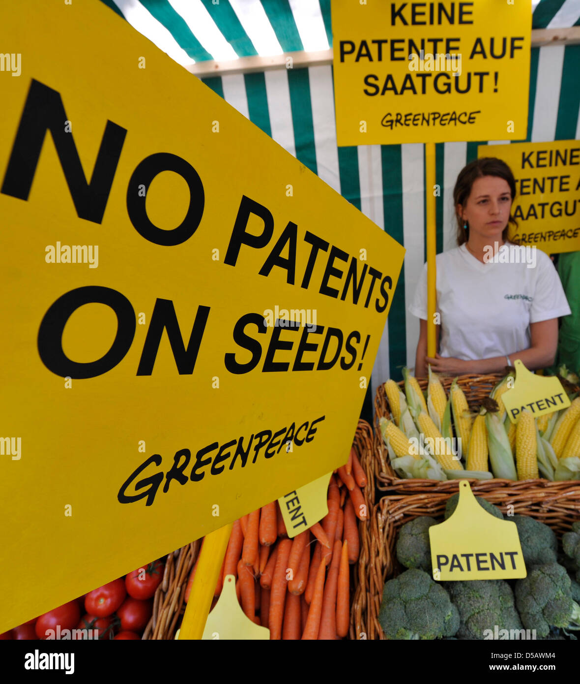 Several Greenpeace activists show signs saying 'No patents on seeds' and  'Keine Patente auf Saatgut' at a vegetable stand in front of the European  Patent Office (EPO) in Munich, Germany, 20 July