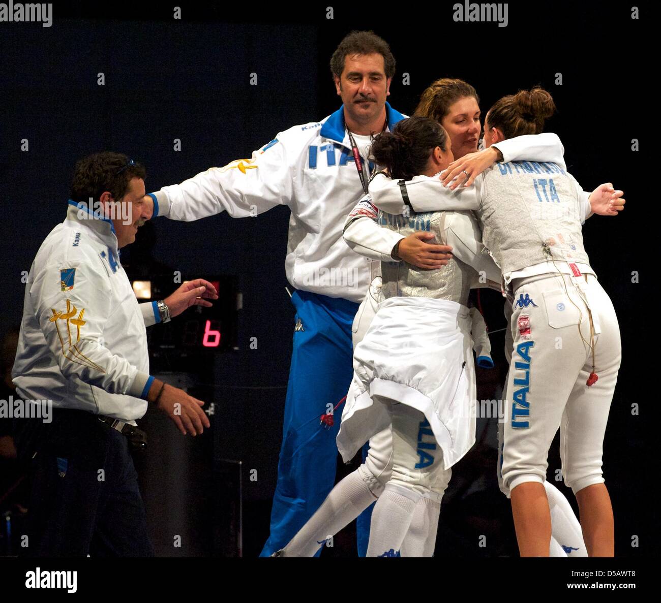 Next to their coaches Giulio Tomassini (L-R) and Stefano Cerioni, foil  fencers Ilaria Salvatori, Arianna Errigo and Elisa Di Francisca hug after  the fight against the German team at the European Fencing