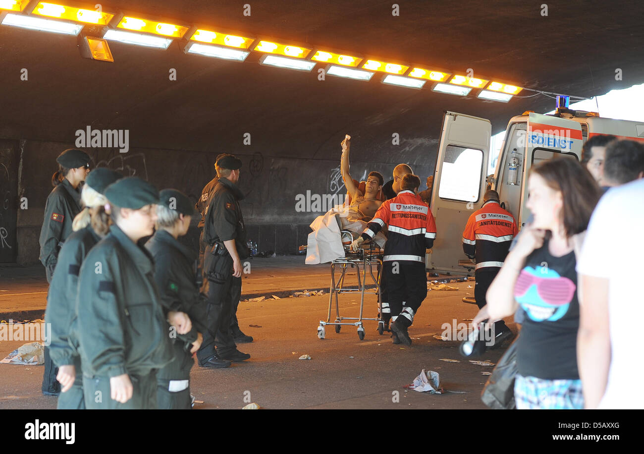 Rescue workers tace care of the injured at the tunnel that was the site of a mass panic that cost 19 lives at the 2010 Love Parade in Duisburg, Germany, 24 July 2010. At least 45 more people have been injured. An estimated million people visited the techno music festival. Photo: Achim Scheidemann Stock Photo