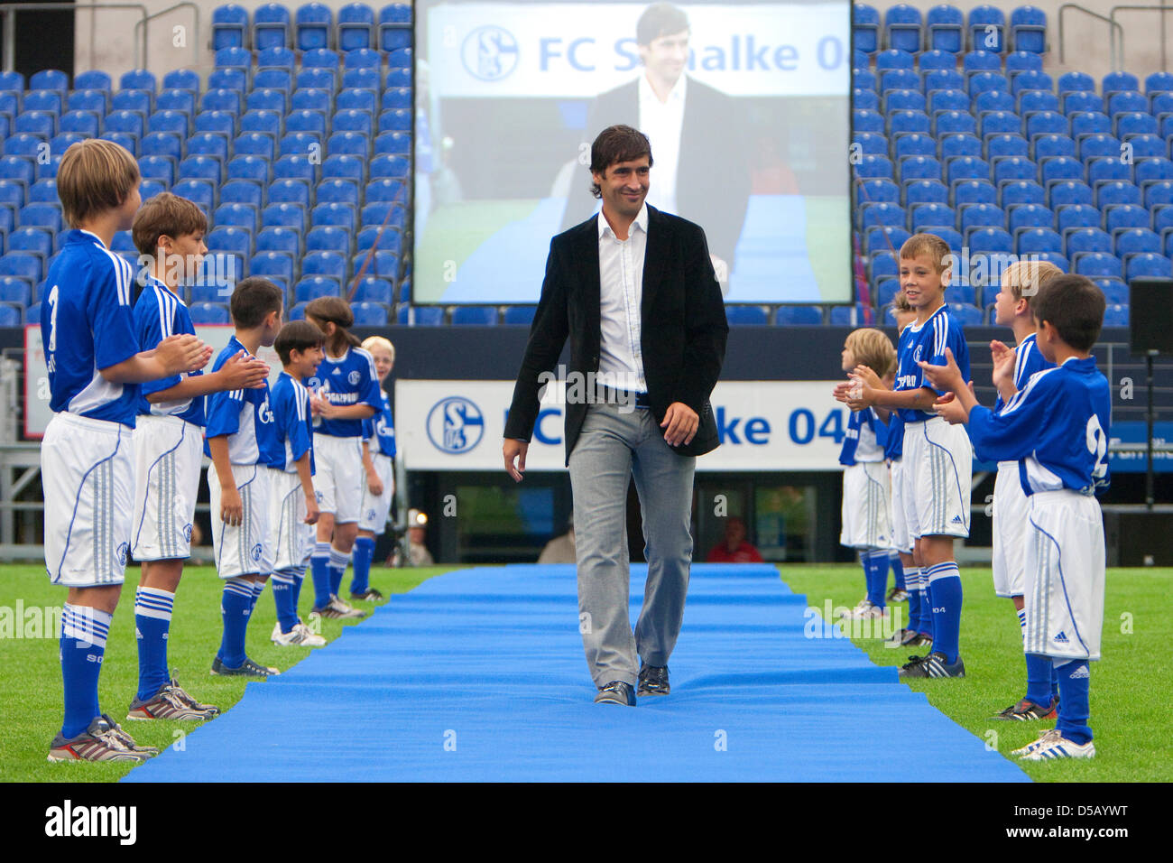 Spanish soccer player Raul walks past a lined-up row of ball boys as he ...