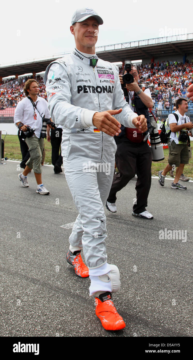 The German Formula One driver Michael Schumacher from Mercedes GP walks  across the starting grid before