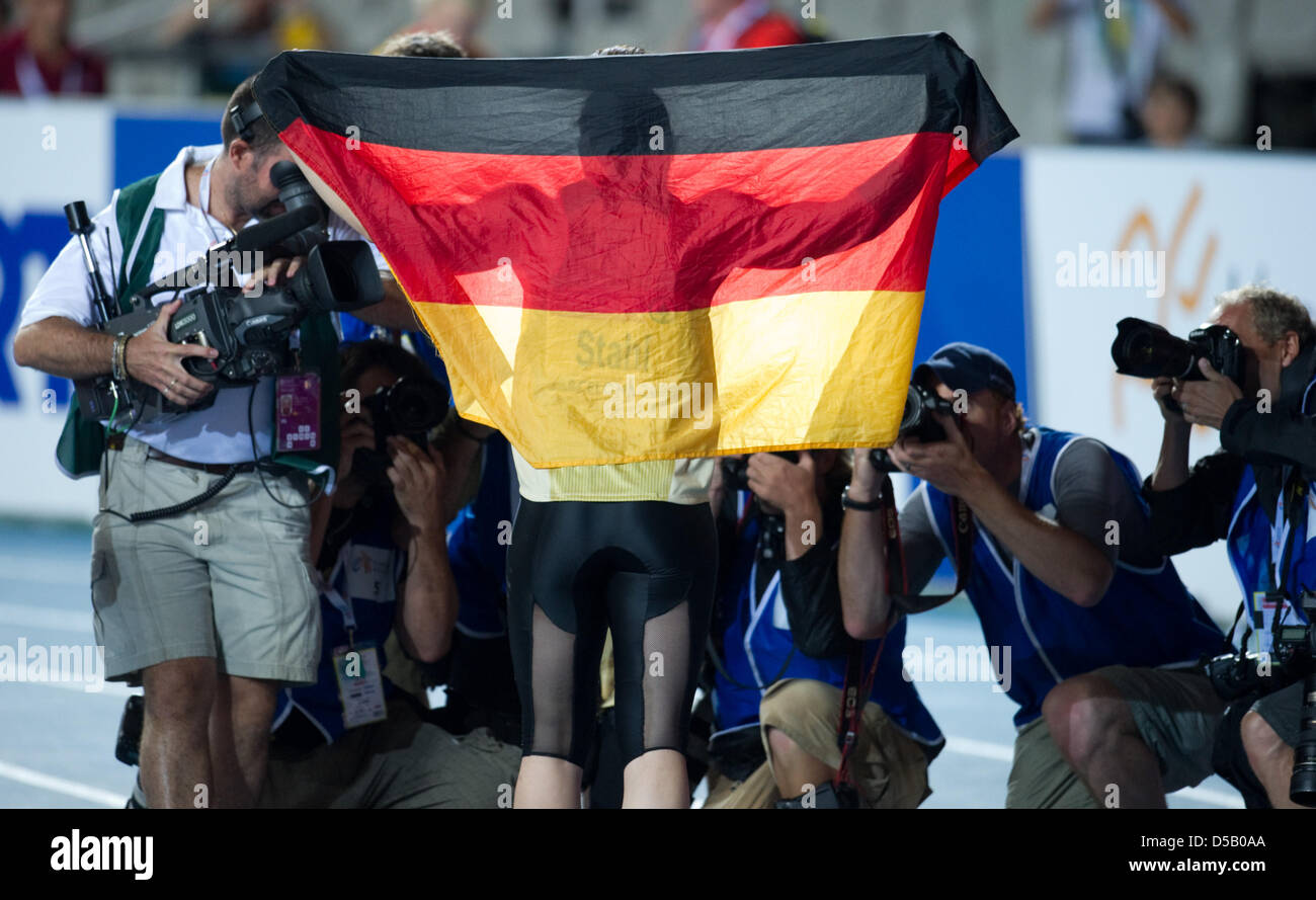 German javelin thrower Linda Stahl holds up a German flag at the Olympic stadium Lluis Companys during the European Athletics Championships in Barcelona, Spain, 29 July 2010. Photo: Rainer Jensen Stock Photo