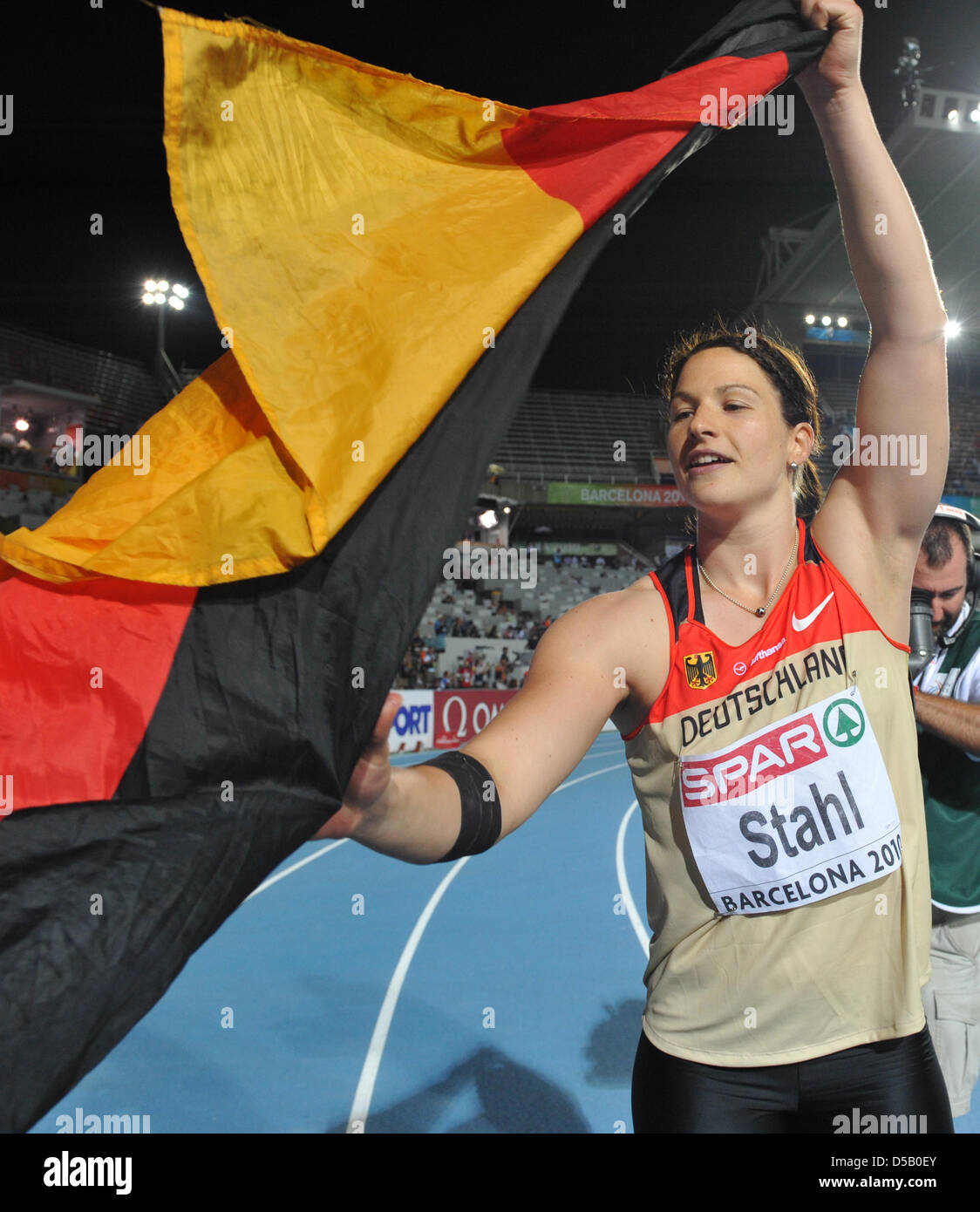 German javelin thrower and freshly crowned European champion Linda Stahl holds up a German flag