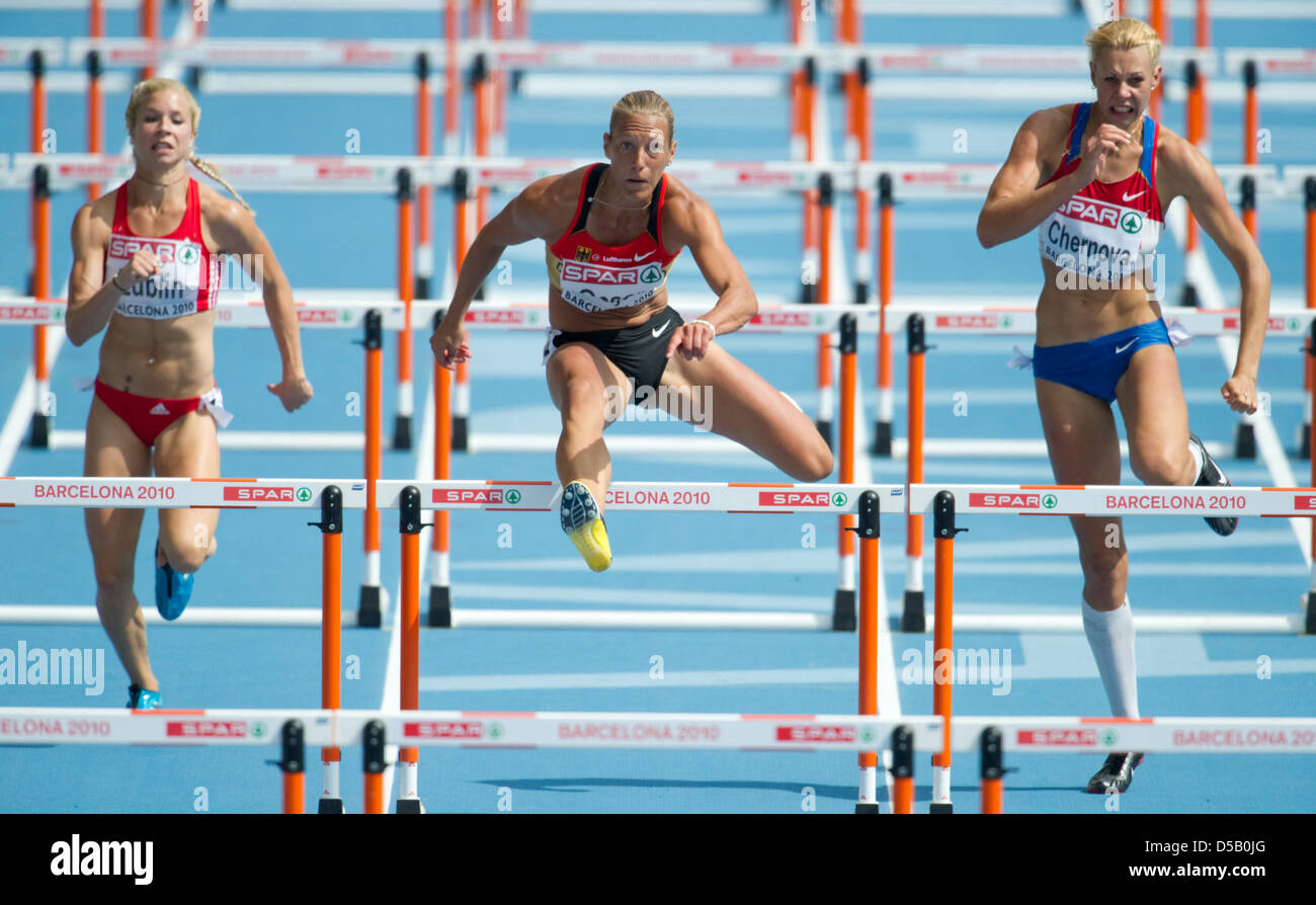 German heptathlete Jennifer Oeser (C) runs the 100 meter hurdles next to Switzerland's Linda Zueblin (L) and Russia's Tatiana Chernova at the Olympic stadium Lluis Companys during the European Athletics Championships in Barcelona, Spain, 29 July 2010. Photo: Bernd Thissen Stock Photo