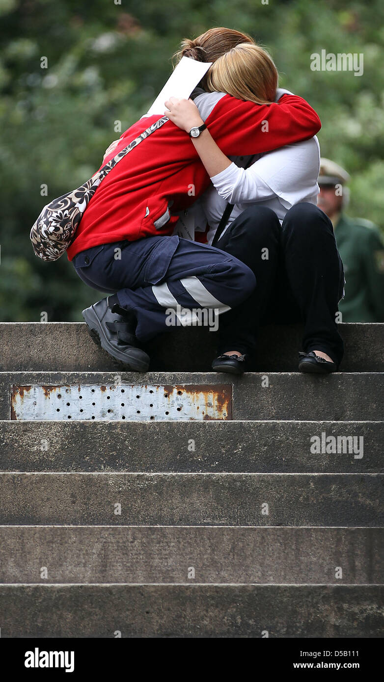 Two crying rescue workers, who have left the church during the memorial ...