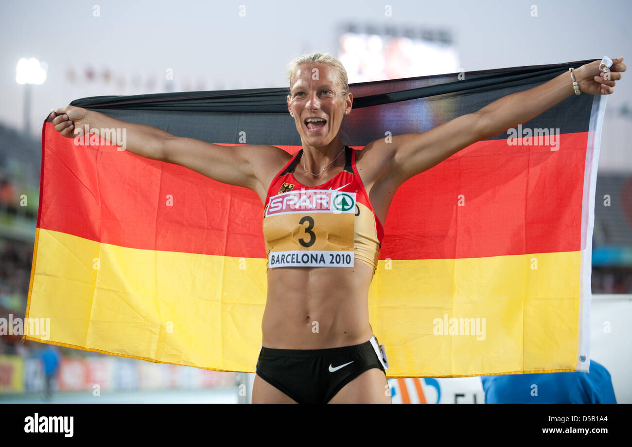 The German heptathlete Jennifer Oeser celebrates her bronze medal with a flag at the European Athletics Championships at Olympic Stadium Lluis Companys in Barcelona, Spain, 31 July 2010. Photo: Bernd Thissen Stock Photo