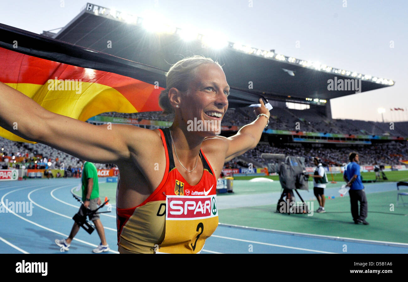 The German heptathlete Jennifer Oeser celebrates her bronze medal with a flag at the European Athletics Championships at Olympic Stadium Lluis Companys in Barcelona, Spain, 31 July 2010. The World Cup second from Leverkusen crowned her excellent heptathlon performance with a personal best. Photo: Rainer Jensen Stock Photo