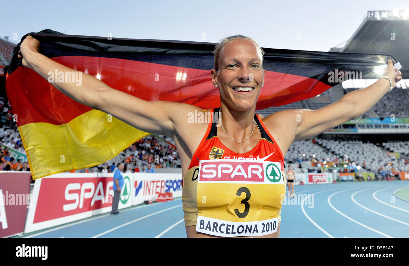 The German heptathlete Jennifer Oeser celebrates her bronze medal with a flag at the European Athletics Championships at Olympic Stadium Lluis Companys in Barcelona, Spain, 31 July 2010. The World Cup second from Leverkusen crowned her excellent hectathlon performance with a personal best. Photo: Rainer Jensen Stock Photo