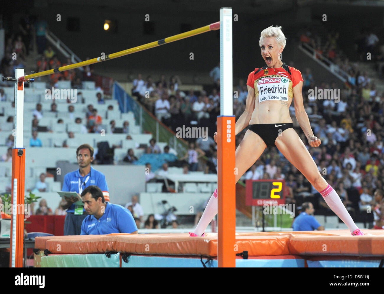 German high jumper Ariane Friedrich leaps up in joy after winning the ...