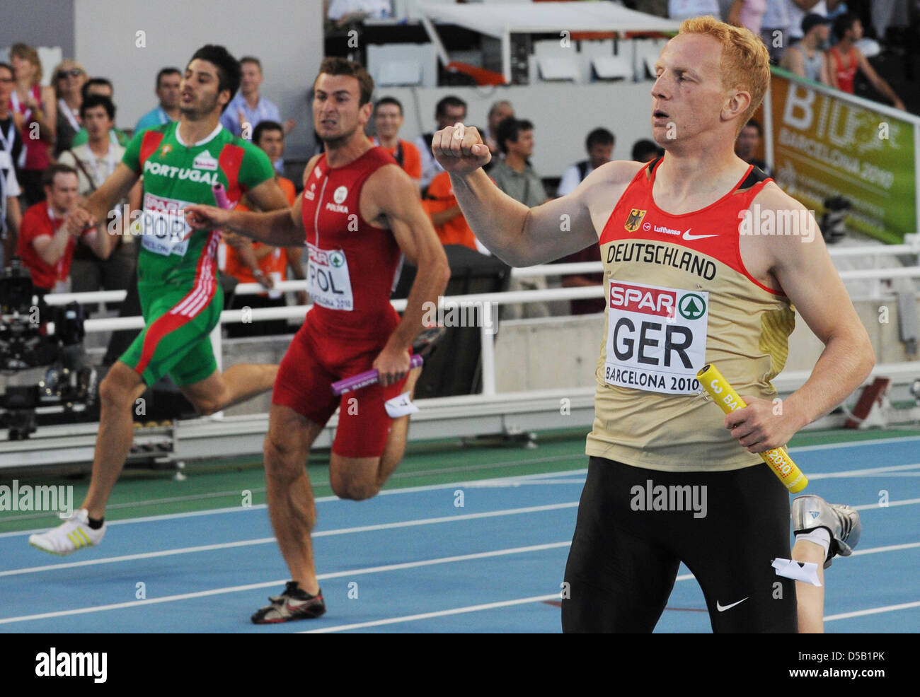 German relay runner Martin Keller (R) crosses the finish line in the 4 x 100 metres relay race at the European Athletics Championship in Barcelona, Spain, 01 August 2010. The German team took third place. Photo: Rainer Jensen Stock Photo