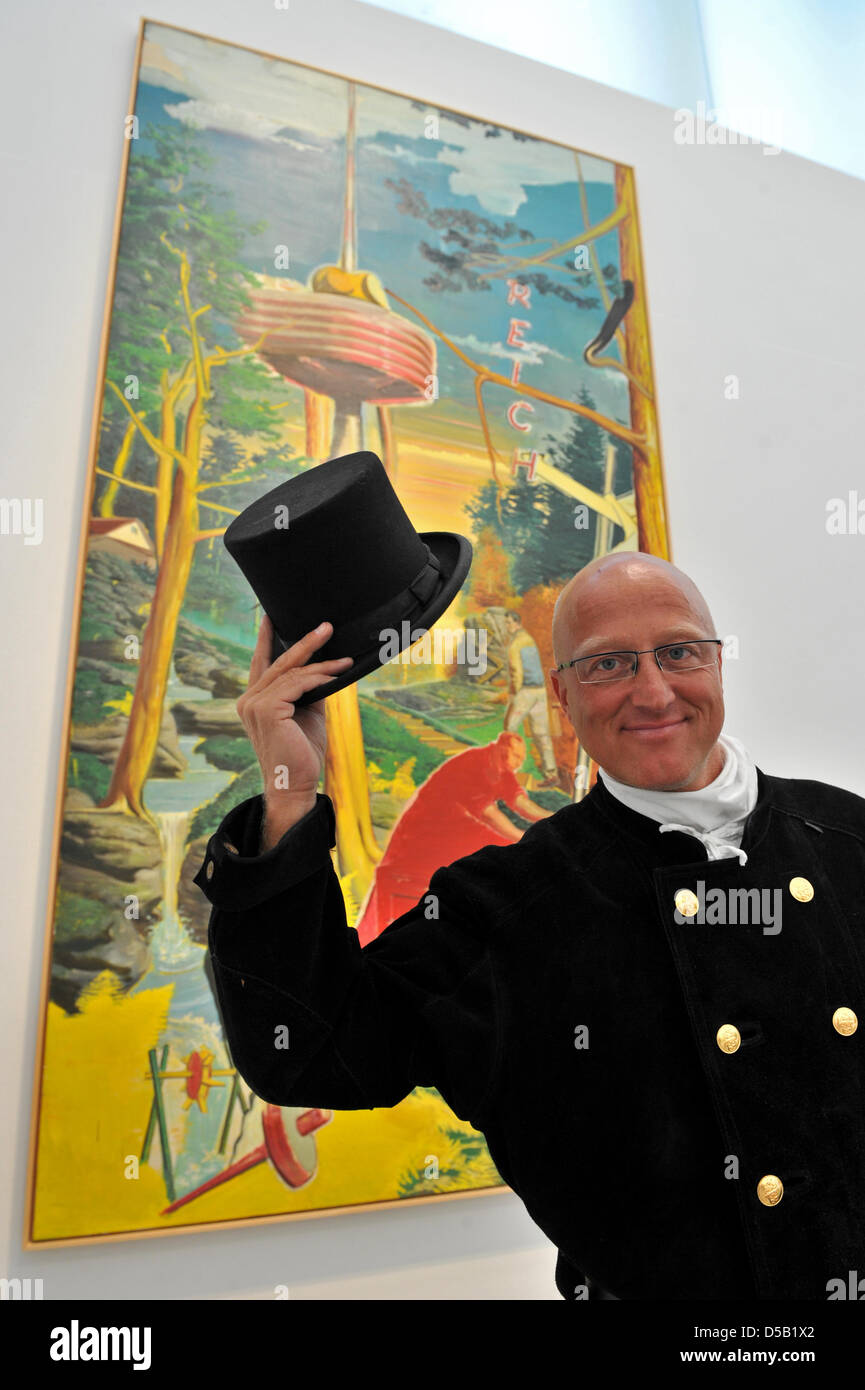 Chimney sweep master craftsman Thomas Zeitler from Leipzig stands in front of the Neo Rauch painting 'Reich' and presents a poster depicting himself in front of the Neo Rauch painting 'Fur' at the Museum of Fine Arts in Leipzig, Germany, 2 August 2010. The poster is part of the campaign 'The masters are here. Where are you?', which wants to attract more visitors from the local area Stock Photo