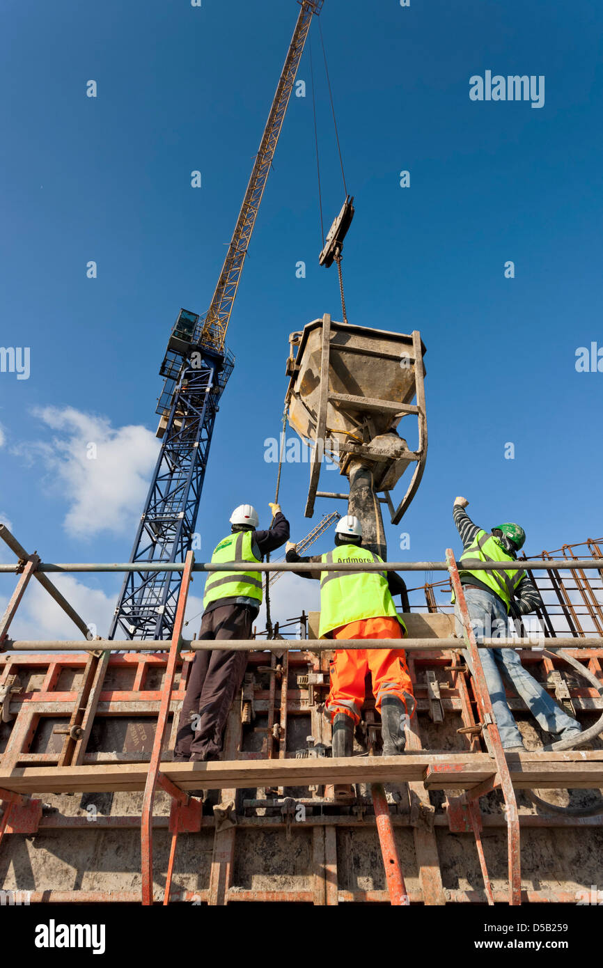 Construction site workers concrete pouring Stock Photo