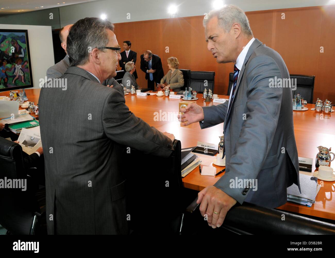 German Home Secretary Thomas de Maizière (L-CDU) and German Minister of Transport Peter Ramsauer (R-CSU)talk to each other prior to the cabinet meeting in the Chancellery in Berlin, Germany, 4 August 2010.  The cabinet meeting discussed changes of the road traffic act and concepts of the government concerning the Caribbian and Latin America. Photo: Tim Brakemeier Stock Photo