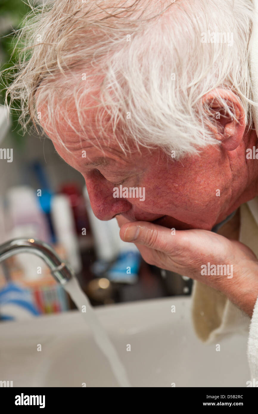 Senior man washing his face after shaving Stock Photo Alamy