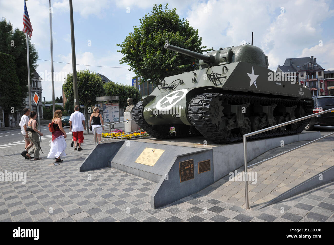 A Sherman tank and the General McAuliffe memorial pictured on the McAuliffe square in Bastogne, Belgium, August 2009. US army General Anthony Clement McAuliffe was a war hero of the battle in Bastogne and became famous for answering ?Nuts? to the German demand for capitulation on 22 December 1944. The allied victory in Bastogne is considered a turning point in Word War II and opene Stock Photo