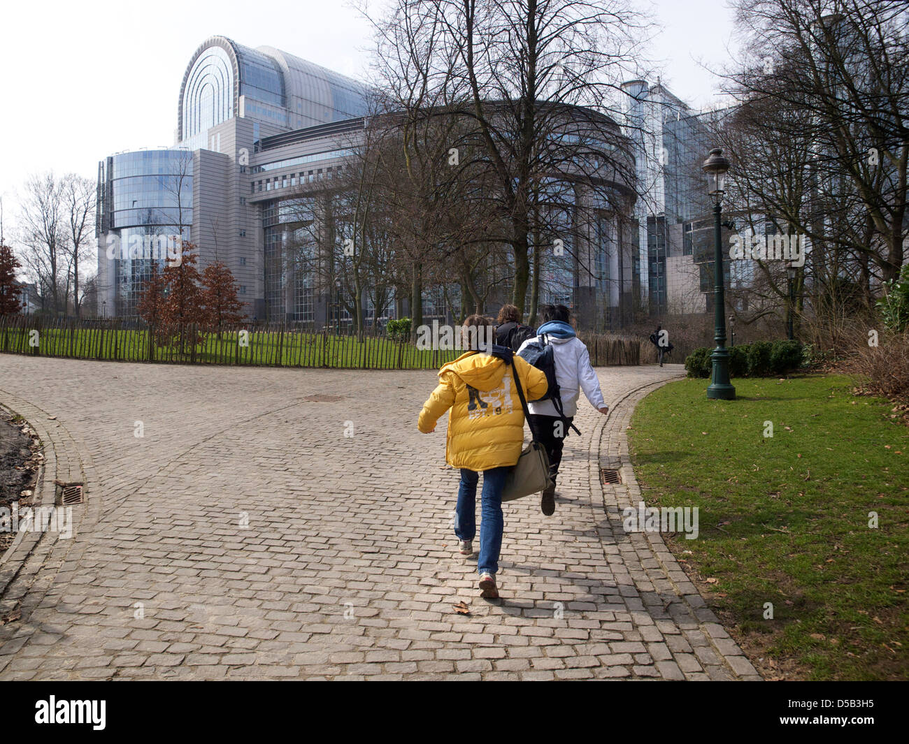 Group of schoolkids running through the Leopoldpark towards the European Union buildings Brussels Belgium Stock Photo