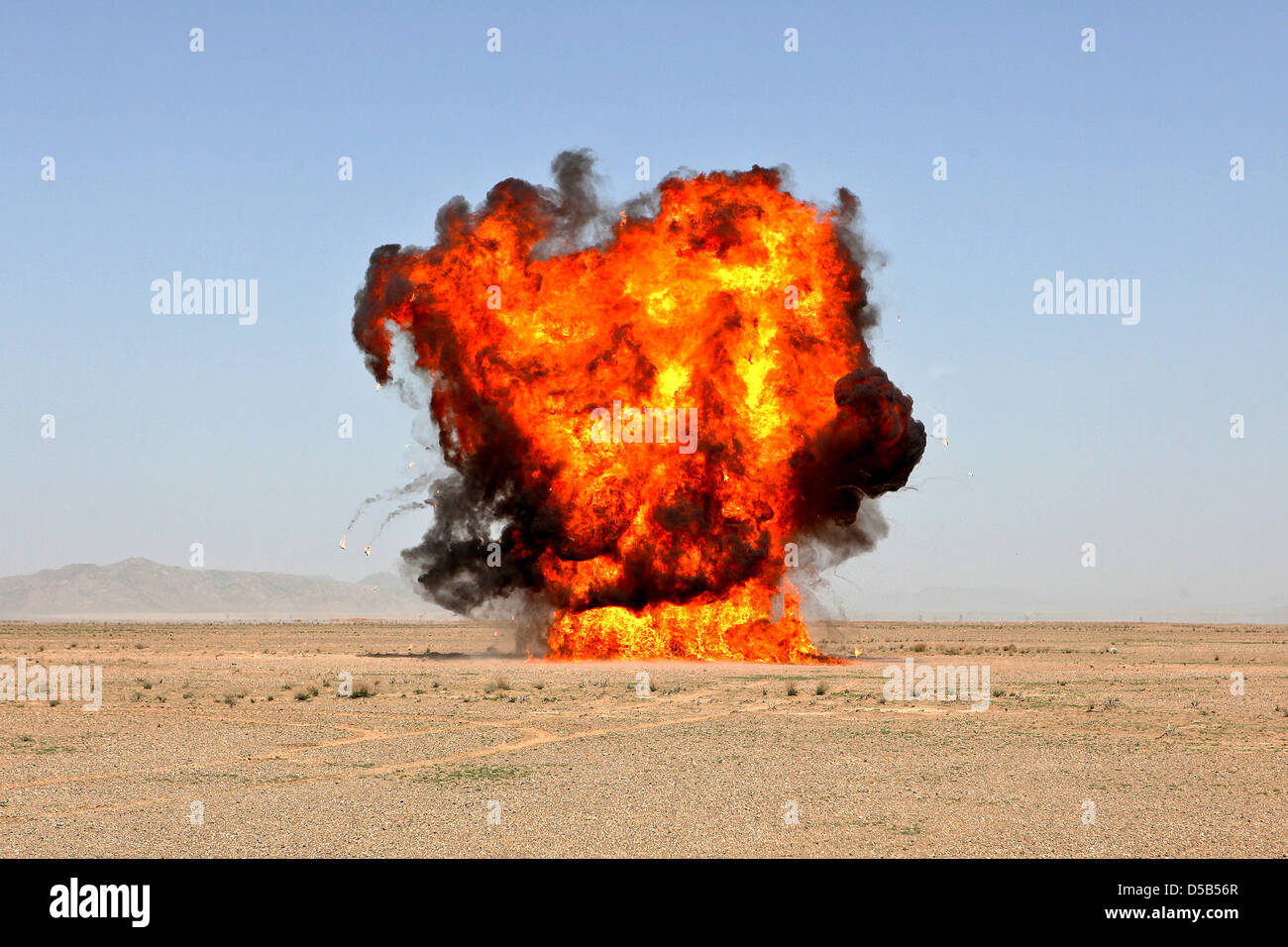 US Marines with 1st Explosive Ordnance Disposal Company conduct a controlled explosion to dispose of dangerous ammunition March 17, 2013 in Helmand province, Afghanistan. Stock Photo