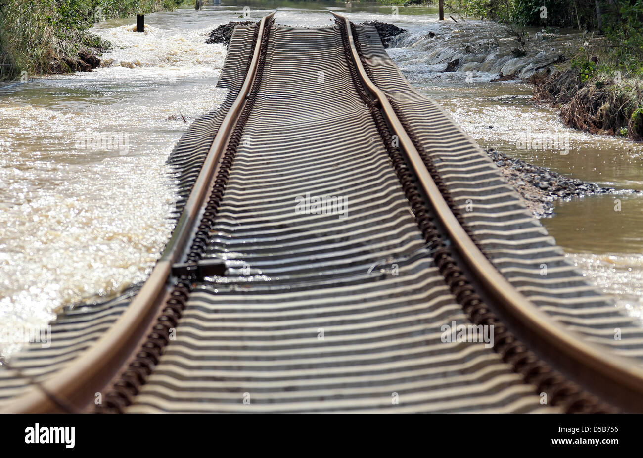 Railway tracks bend after they have been washed out by high water in